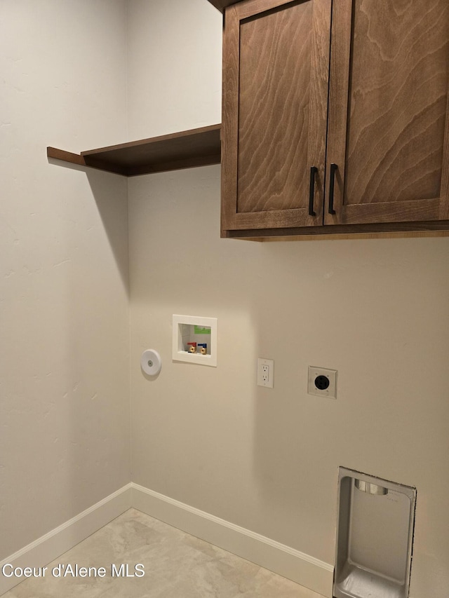 laundry room featuring electric dryer hookup, hookup for a washing machine, light tile patterned floors, and cabinets