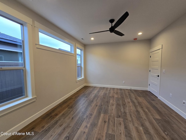 spare room featuring ceiling fan and dark wood-type flooring