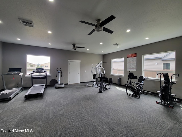 gym featuring carpet flooring, a textured ceiling, and ceiling fan