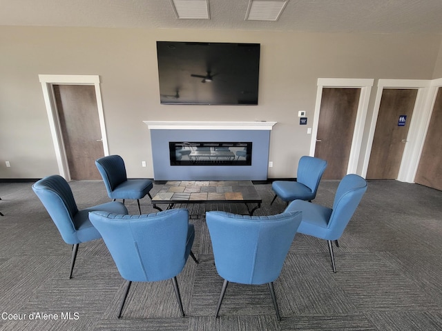 living room with dark colored carpet