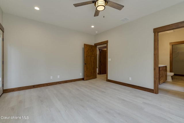 unfurnished bedroom featuring light hardwood / wood-style floors, ensuite bath, and ceiling fan