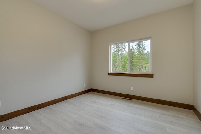 spare room featuring light wood-type flooring