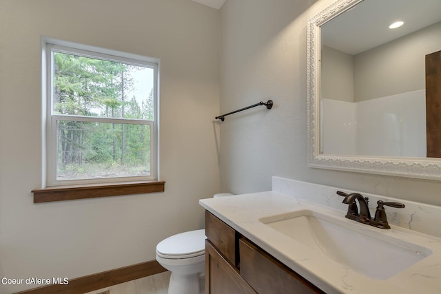 bathroom featuring vanity and toilet