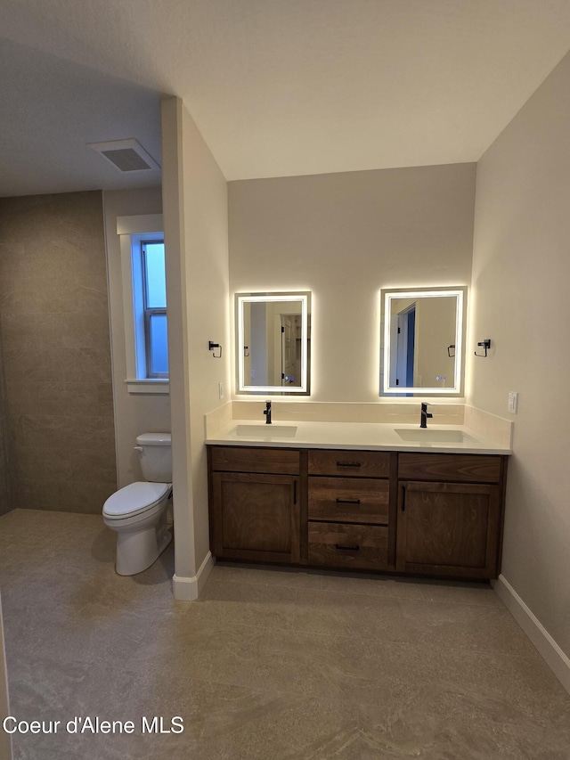 bathroom featuring vanity and toilet