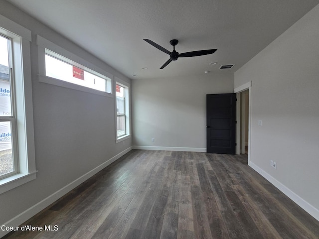 unfurnished room with dark hardwood / wood-style floors and ceiling fan