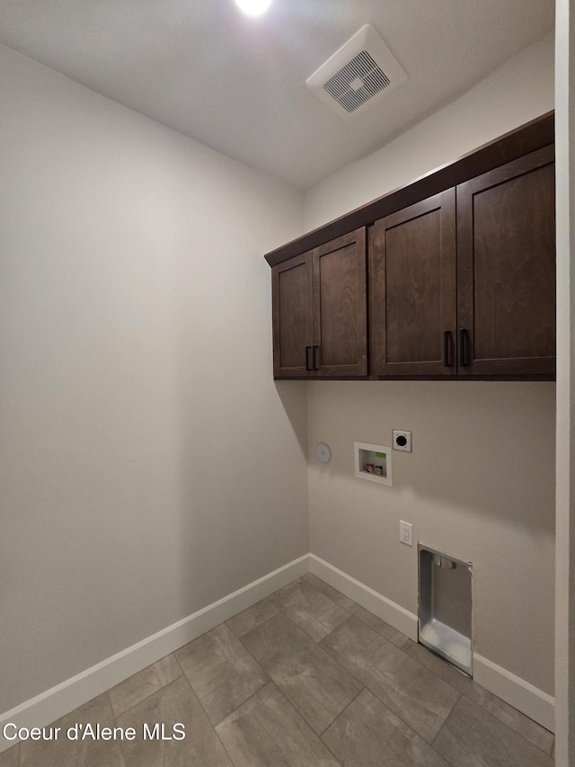 laundry room with electric dryer hookup, washer hookup, hookup for a gas dryer, and cabinets