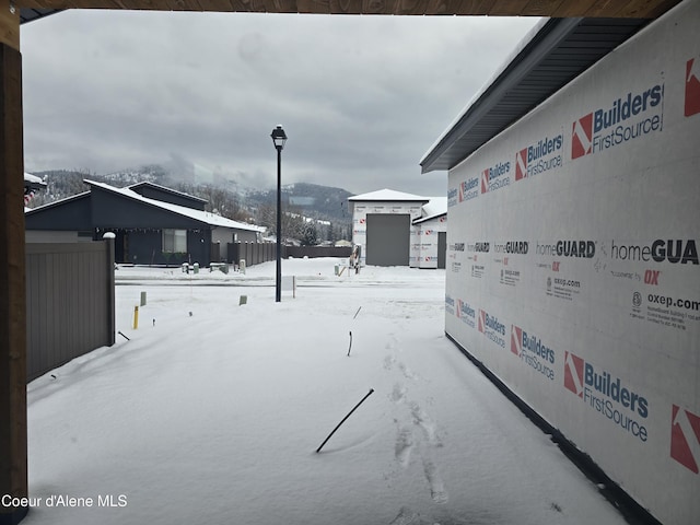 yard covered in snow with a mountain view