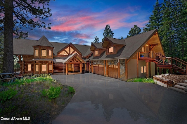 log-style house with a garage