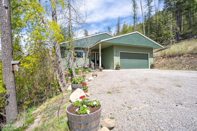 ranch-style house featuring an attached garage and driveway