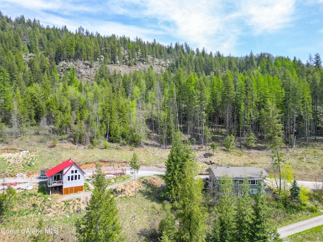 drone / aerial view with a wooded view