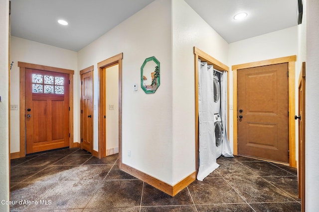 entrance foyer featuring stacked washer / drying machine