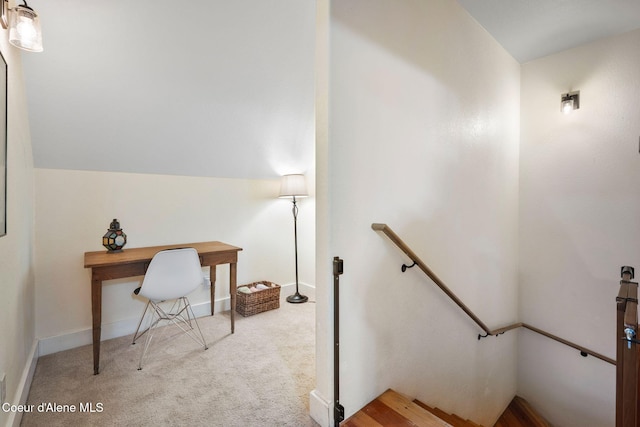 carpeted office with vaulted ceiling