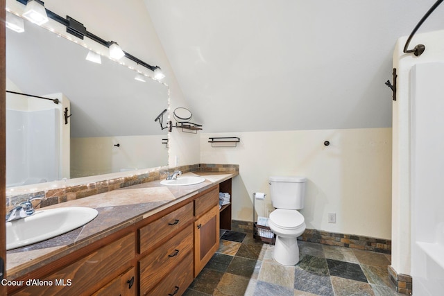 bathroom featuring lofted ceiling, toilet, vanity, and a shower