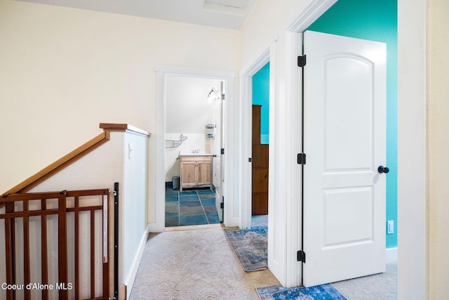 hallway with light colored carpet