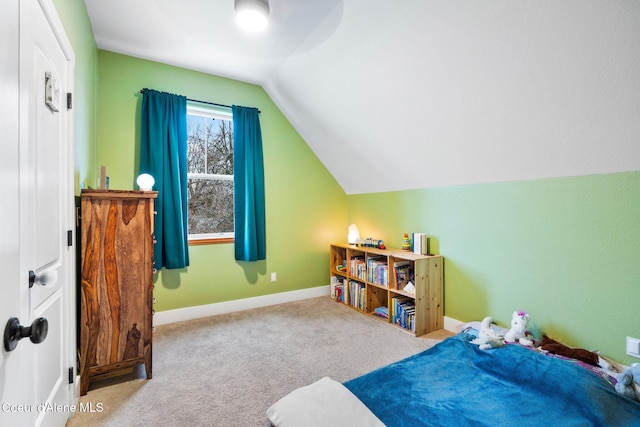 bedroom with vaulted ceiling and light carpet