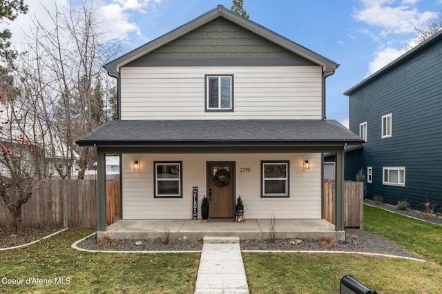 view of front of home with covered porch and a front lawn