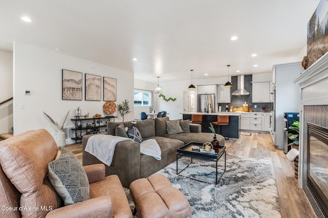 living room with light hardwood / wood-style floors and a fireplace