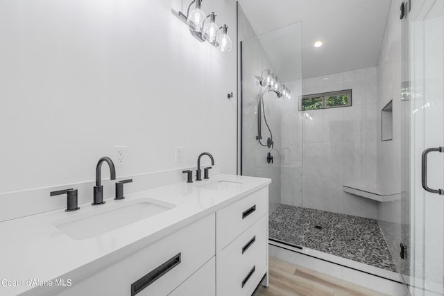 bathroom with vanity, wood-type flooring, and an enclosed shower