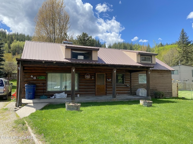 log home featuring a front yard and a porch