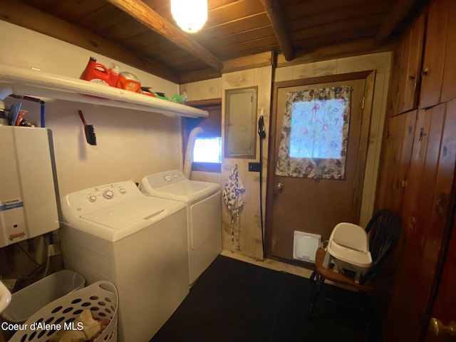 laundry area with tankless water heater, electric panel, wood walls, washer and clothes dryer, and wood ceiling