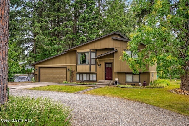 raised ranch with a garage and a front yard