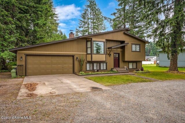 split foyer home featuring a garage and a front yard