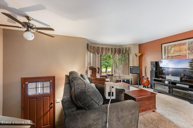 carpeted living room featuring ceiling fan