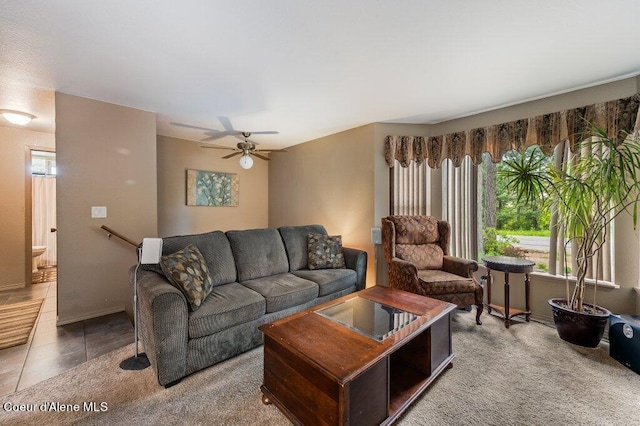 living room featuring ceiling fan and tile patterned floors