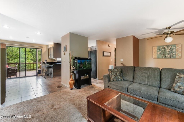 living room with light tile patterned flooring and ceiling fan