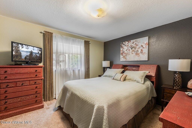 bedroom featuring carpet and a textured ceiling