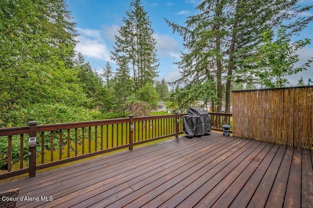 wooden deck with a grill