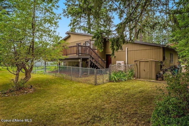 view of yard with a wooden deck and a storage unit