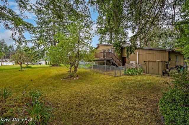 view of yard with a wooden deck and a shed