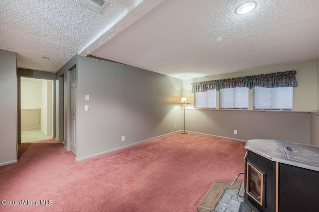 carpeted spare room with a textured ceiling