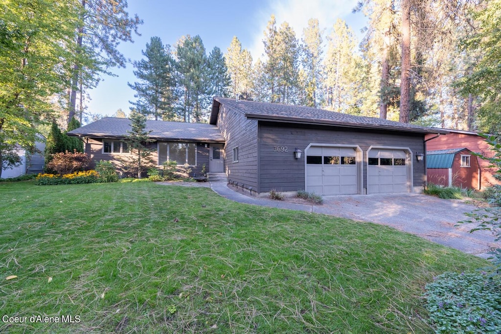 view of front of house with a front yard and a garage