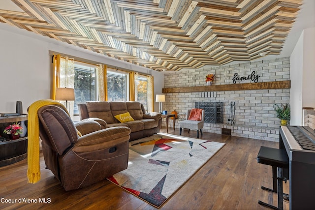 living room with dark hardwood / wood-style flooring and a brick fireplace