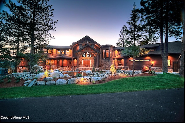 view of front of property featuring a lawn and a garage