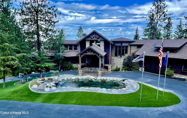 view of front of home featuring a garage and a front lawn
