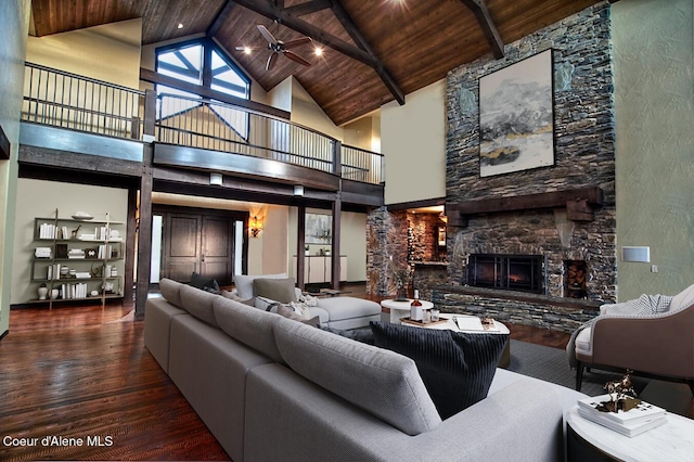 living room featuring a fireplace, high vaulted ceiling, and wooden ceiling