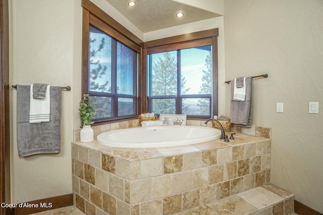 bathroom featuring tiled tub