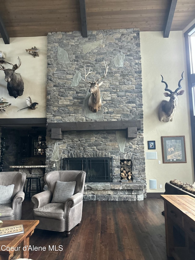 living room featuring hardwood / wood-style floors, a fireplace, beamed ceiling, and wooden ceiling