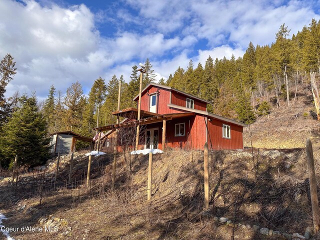 4333 Old Highway Two Loop, Moyie Springs, ID 83845 - rear view of property featuring a deck and a view of trees