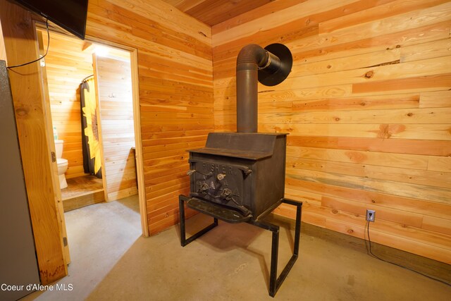 4333 Old Highway Two Loop, Moyie Springs, ID 83845 - detailed view of wood walls, concrete floors, and a wood stove