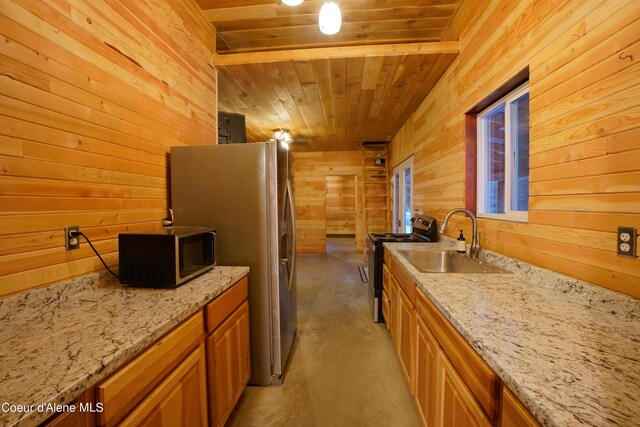 4333 Old Highway Two Loop, Moyie Springs, ID 83845 - kitchen featuring appliances with stainless steel finishes, wooden walls, wood ceiling, light stone countertops, and concrete flooring