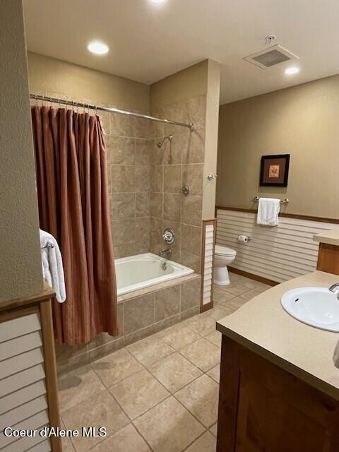 full bathroom with toilet, shower / tub combo, vanity, and tile patterned floors