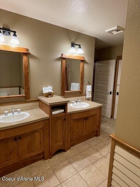 bathroom with tile patterned floors and vanity