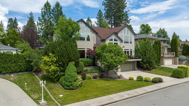 view of front of house featuring a garage, a front lawn, and driveway