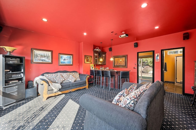 carpeted living area featuring bar area and recessed lighting