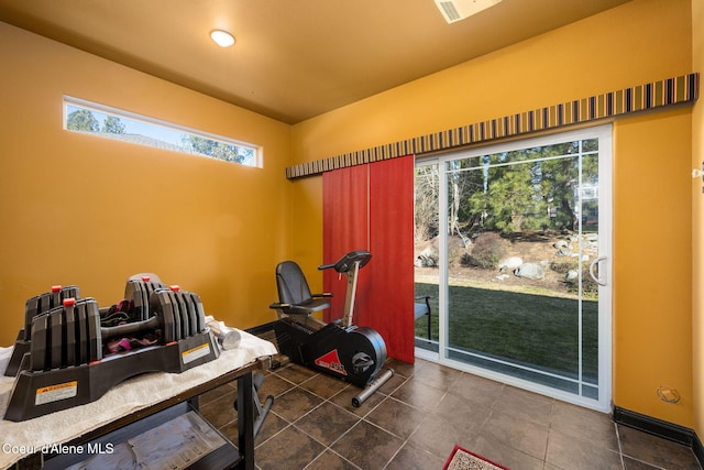 workout room featuring dark tile patterned floors