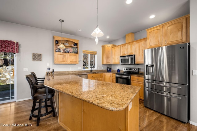 kitchen featuring recessed lighting, light stone countertops, appliances with stainless steel finishes, and dark wood-style floors